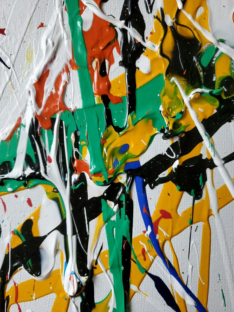 Close-up of thick, dripped paint in green, yellow, red and black